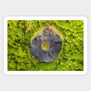 Round lake with island in the middle among forest Sticker